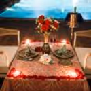 Elegant rooftop cabana dining beside the pool at Hilton Garden Inn Baani Square, where candlelight and romance meet luxury.