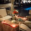 A beautifully styled private cabana at Hilton Baani Square offering a dreamy poolside dining experience for couples.
