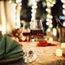 Romantic rooftop dining at Hilton Baani Square with a candlelit table, floral décor, and serene poolside ambiance.
