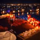 Poolside rooftop dining at Davanam Sarovar Portico Koramangala, where city lights create the perfect romantic mood.