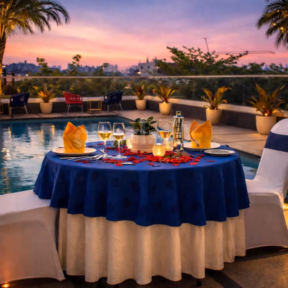 A dreamy rooftop poolside candlelight dinner at Clarion Hotel Bangalore, perfect for a romantic evening under the sunset sky.