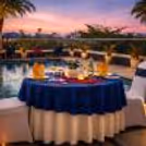 A dreamy rooftop poolside candlelight dinner at Clarion Hotel Bangalore, perfect for a romantic evening under the sunset sky.