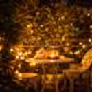Soft candlelight, blooming flowers, and a private table made just for two