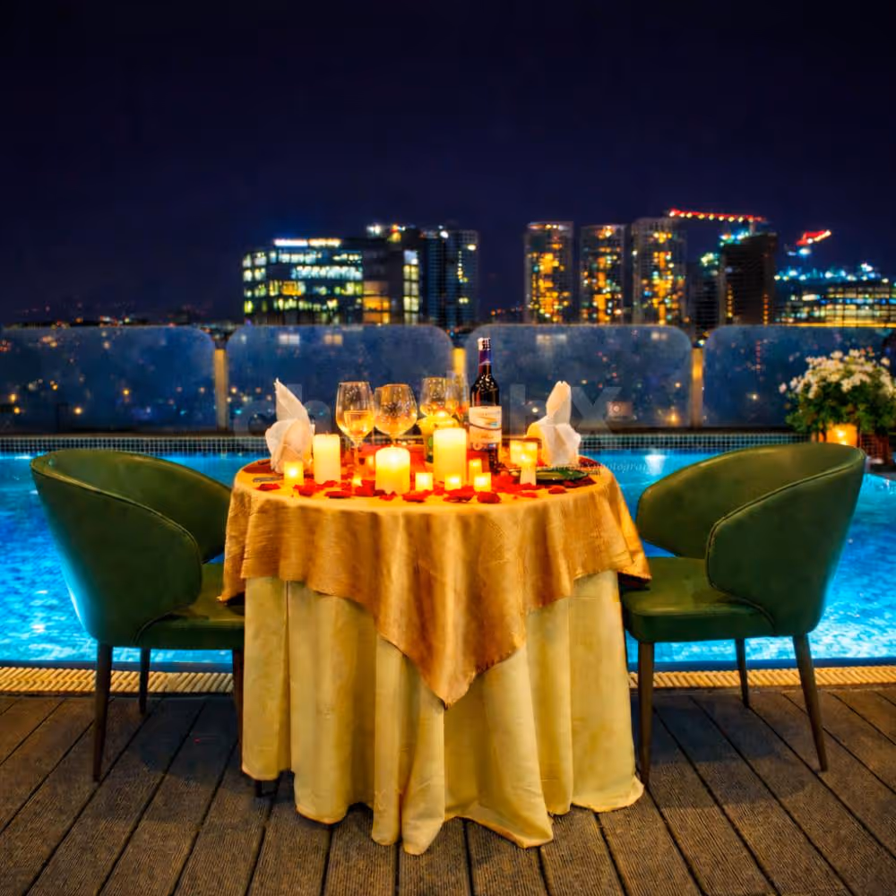 An intimate poolside candlelight dinner under the Bangalore skyline at Country Inn