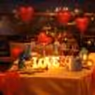 A beautifully decorated table, warm candlelight, and skyline views create the perfect romantic evening at Royal Orchid