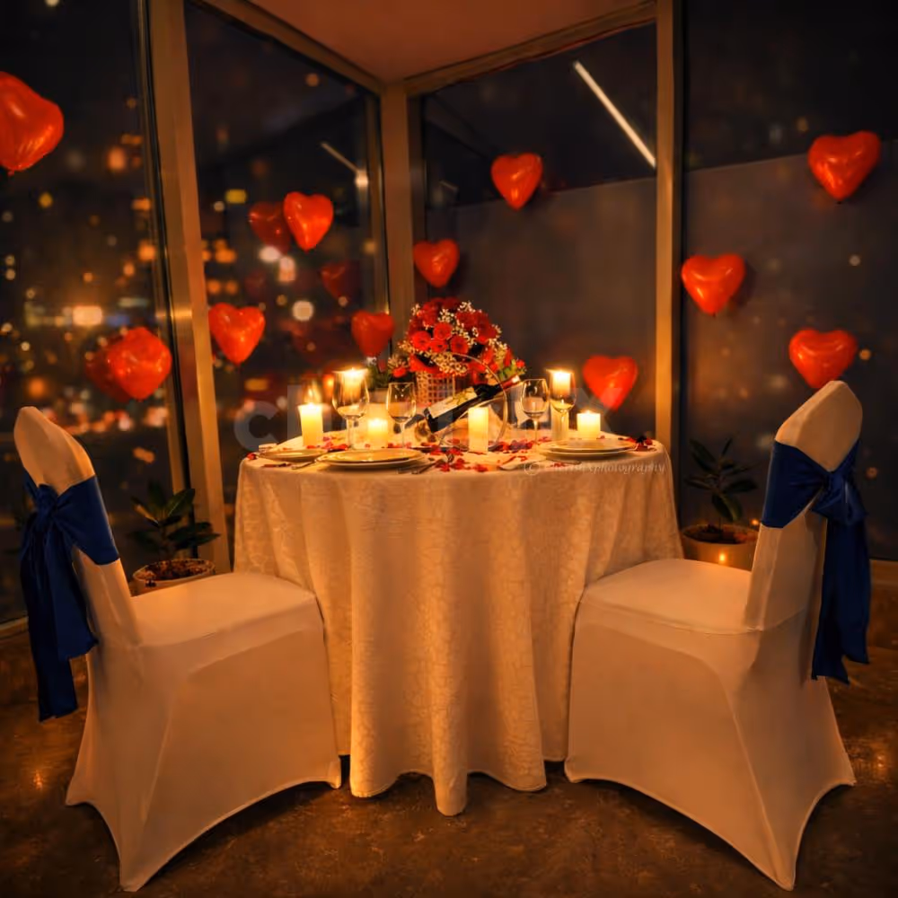 A dreamy private candlelight dinner setup with roses, floating heart balloons and glowing candles at Holiday Inn Bangalore.