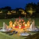 A Couple Enjoying A Peaceful Dinner Under The Sky With Good Food And Music