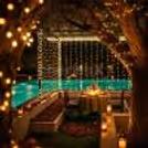 Beautiful Candlelight Table Decoration With Flowers Near The Poolside Area