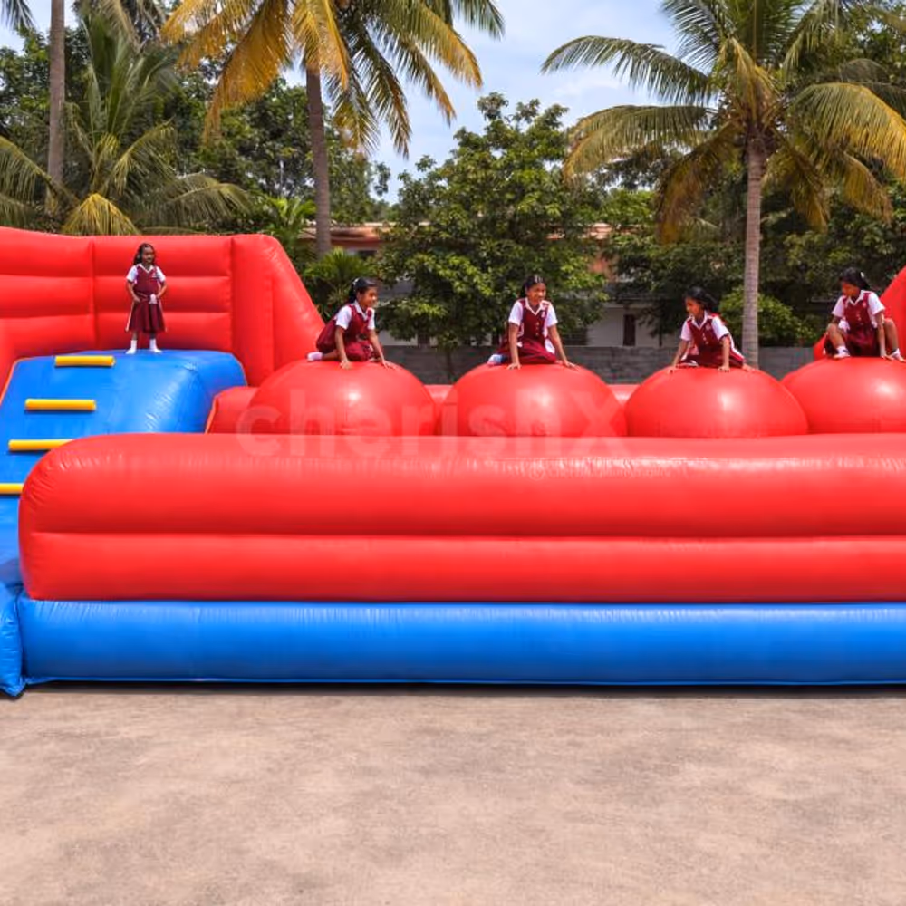 Kids enjoying giant inflatable obstacle bouncy setup with climbing and sliding activities at birthday party