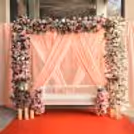 Flowers on the stand in front of fabric draping weave floral elegance in the celebration.