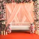 Red carpet and vases on cone tables enhance the setup's grace and aesthetic appeal.