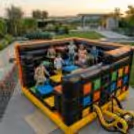 Kids Enjoy Climbing And Sliding In The Inflatable Obstacle Maze With Partners