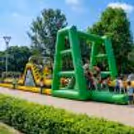 Kids Running, Climbing, And Sliding On An Inflatable Adventure Track Enhance Physical Power