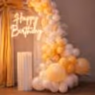 Apricot macaron balloons add the layering effect in the arch with their grand size.