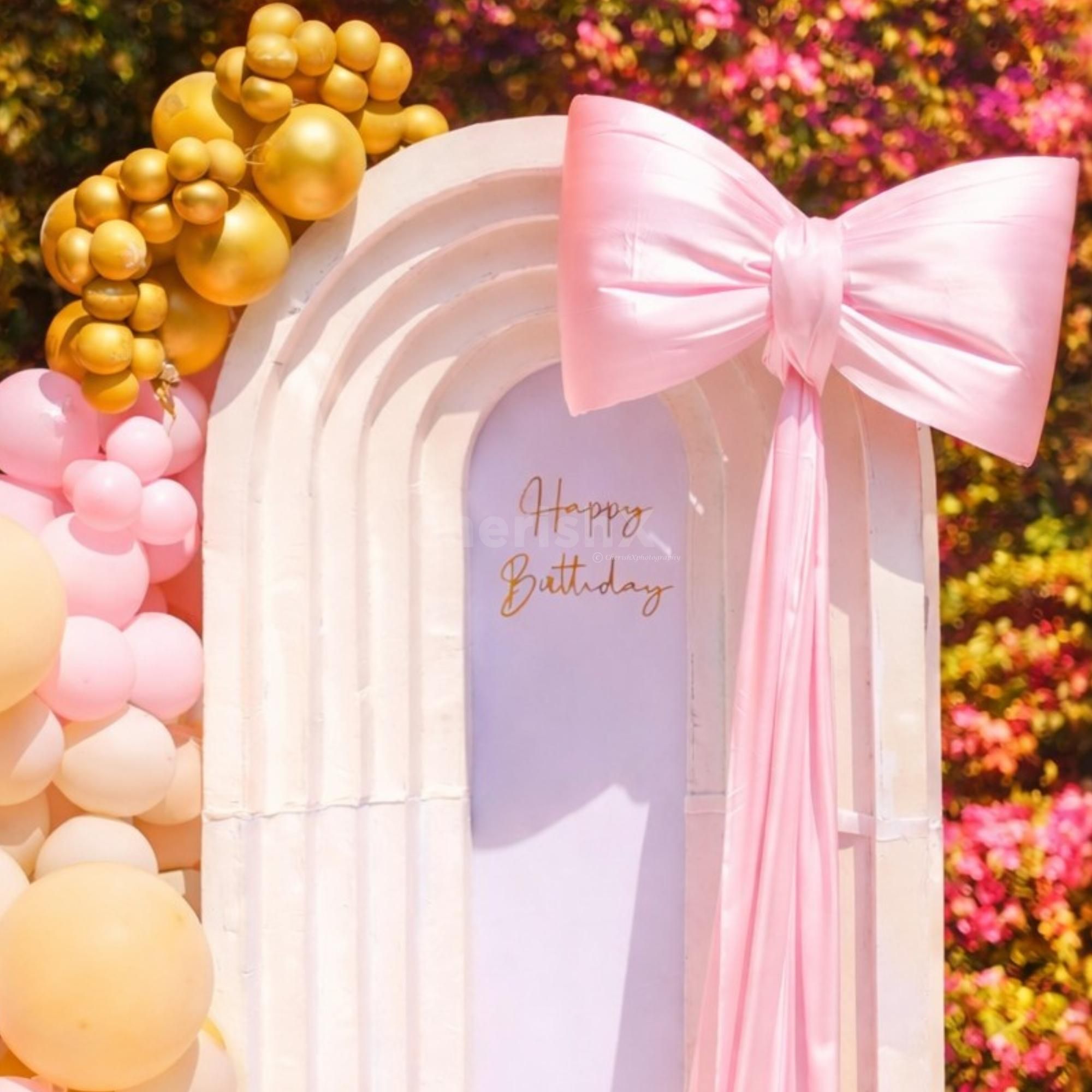 A balloon arch in soft tones feels like pure bliss for a birthday celebration of any age.