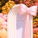 A balloon arch in soft tones feels like pure bliss for a birthday celebration of any age.
