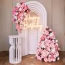 A white sunboard backdrop with a 3D effect adds to the visual appeal of the birthday spot.