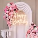 The large white cake table complements the white 3D cutout at the back.