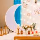 Eid Mubarak sunboard cutout with moon and scattered stars creates a sky-like effect.