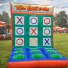 Kids Are Enjoying Different Games In A Colorful Carnival-Themed Inflatable Bouncy Setup