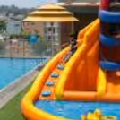 Kids Enjoying Jumping, Sliding, And Playing In An Inflatable Pool Bouncy