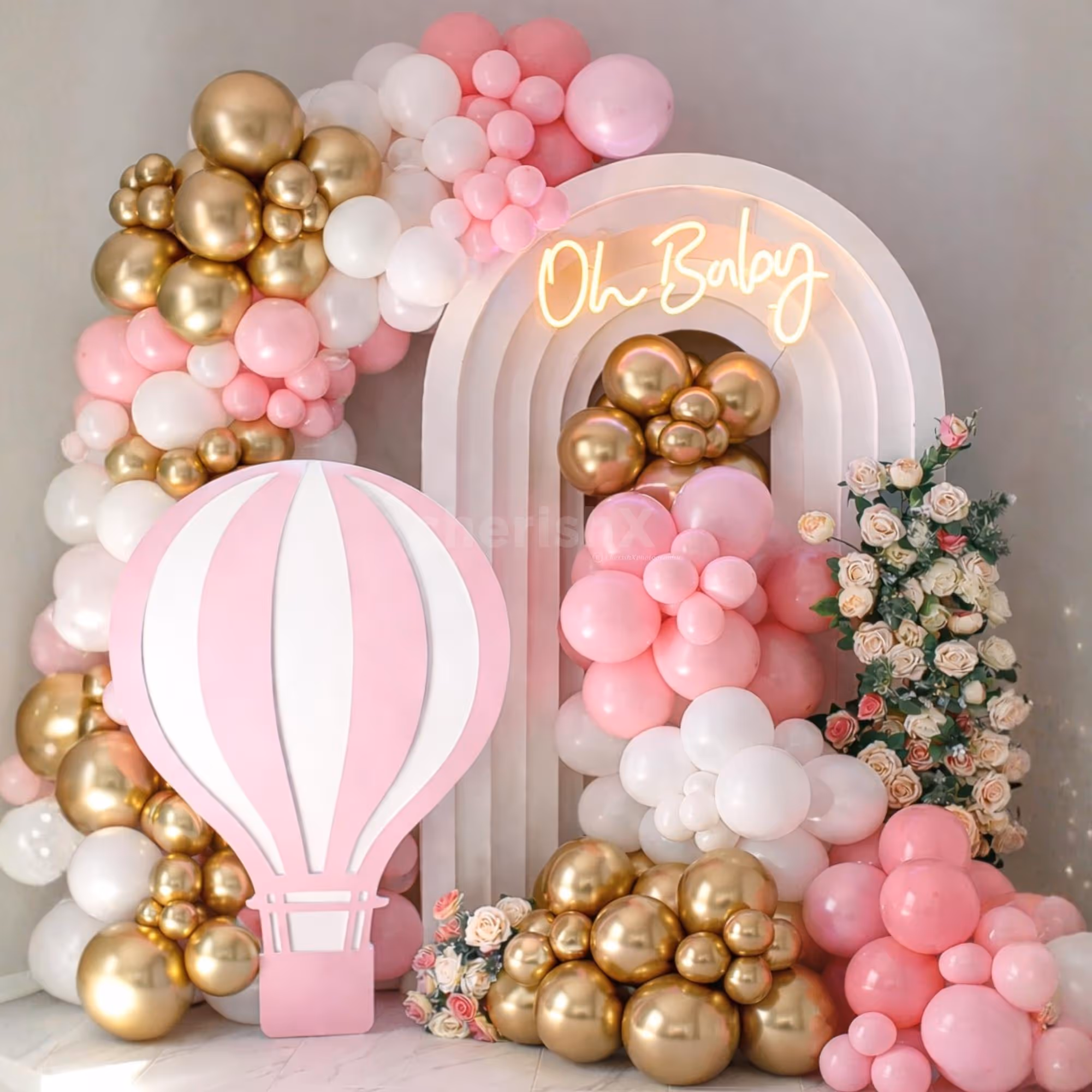 A pink parachute sunboard cutout with a stand makes baby shower decor unique and trendy.