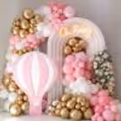 A pink parachute sunboard cutout with a stand makes baby shower decor unique and trendy.