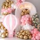 An organic balloon cluster in pastel and blush pink, white, and golden is eye-catching.