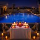 Poolside Seating Enhances The Sensory Experience When Soft Breezes Caress The Couple.