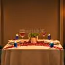 The Table Is Well-Decorated With Candles And Rose Petals, Which Add A Pleasant Aroma To The Air.