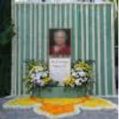 Fresh Flower Backdrop With Green Draping And Floral Rangoli On The Floor For A Peaceful Remembrance Setup