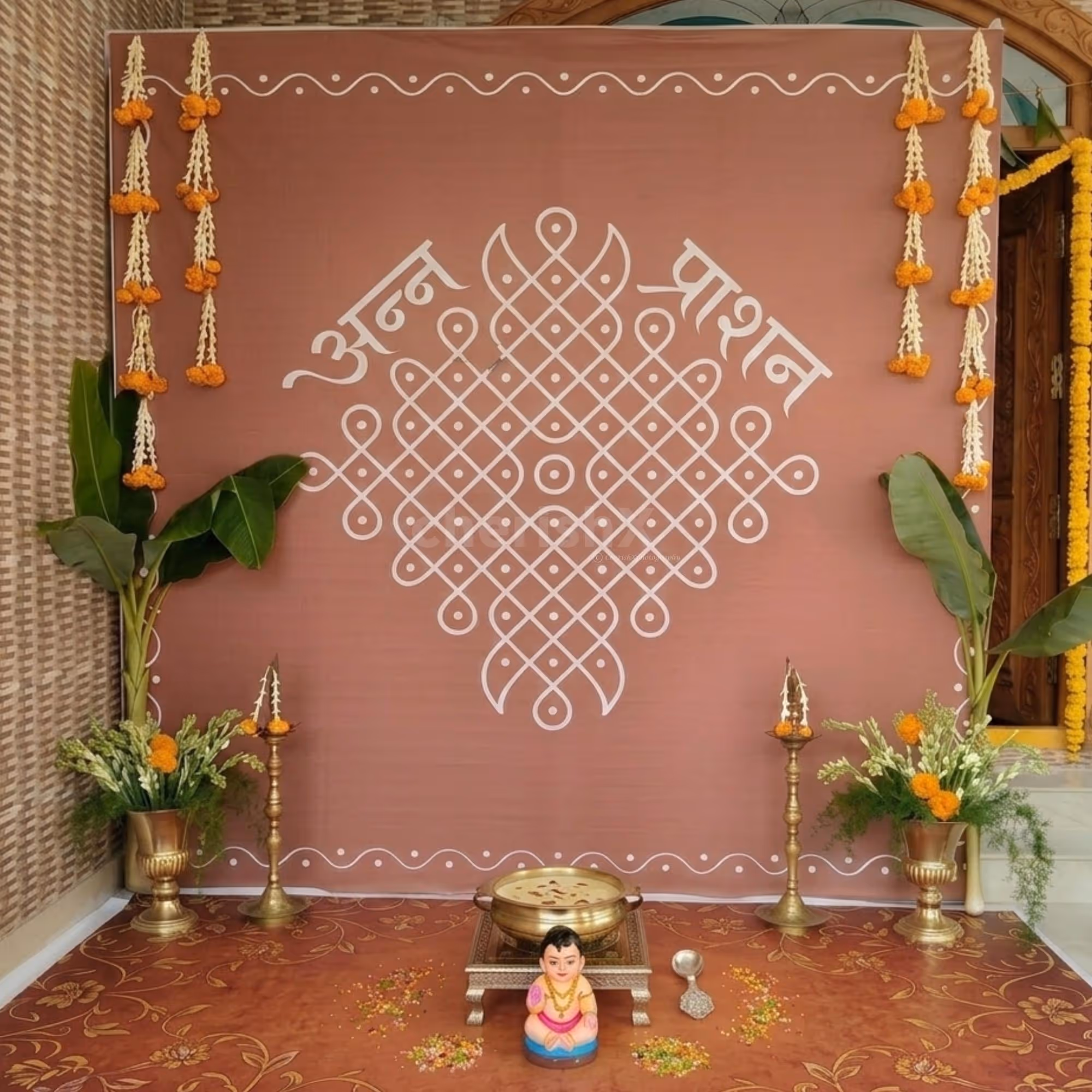 Chowki Setup Placed Neatly In Front Of Flex Backdrop With Stand For The Baby’s Ritual