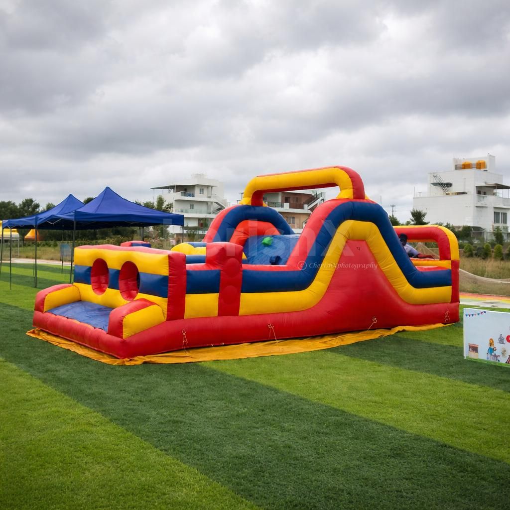 Colorful inflatable challenge arena with climbing and sliding sections for a kids' party activity.