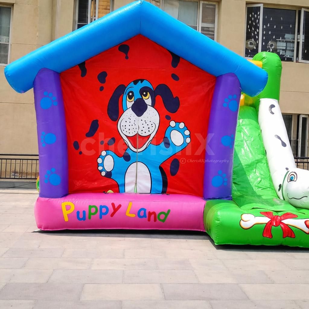 Colorful puppy-themed bouncy house setup for a kids' birthday party celebration
