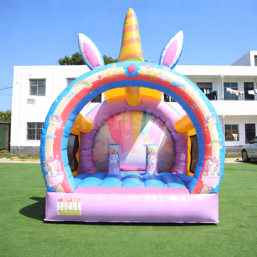 Unicorn-themed inflatable bouncy castle with bright colors for a kids' party