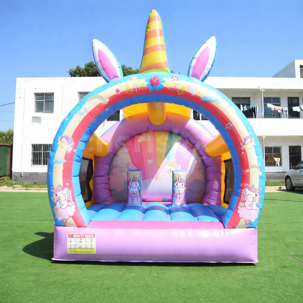 Unicorn-themed inflatable bouncy castle with bright colors for a kids' party