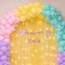 Balloon Arch And Free-Floating Balloons Add Playfulness To The Decor, Framing The Wall.