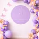 Mom-To-Be Standing Beside Baby Shower Balloon Decor With A Soft Theme