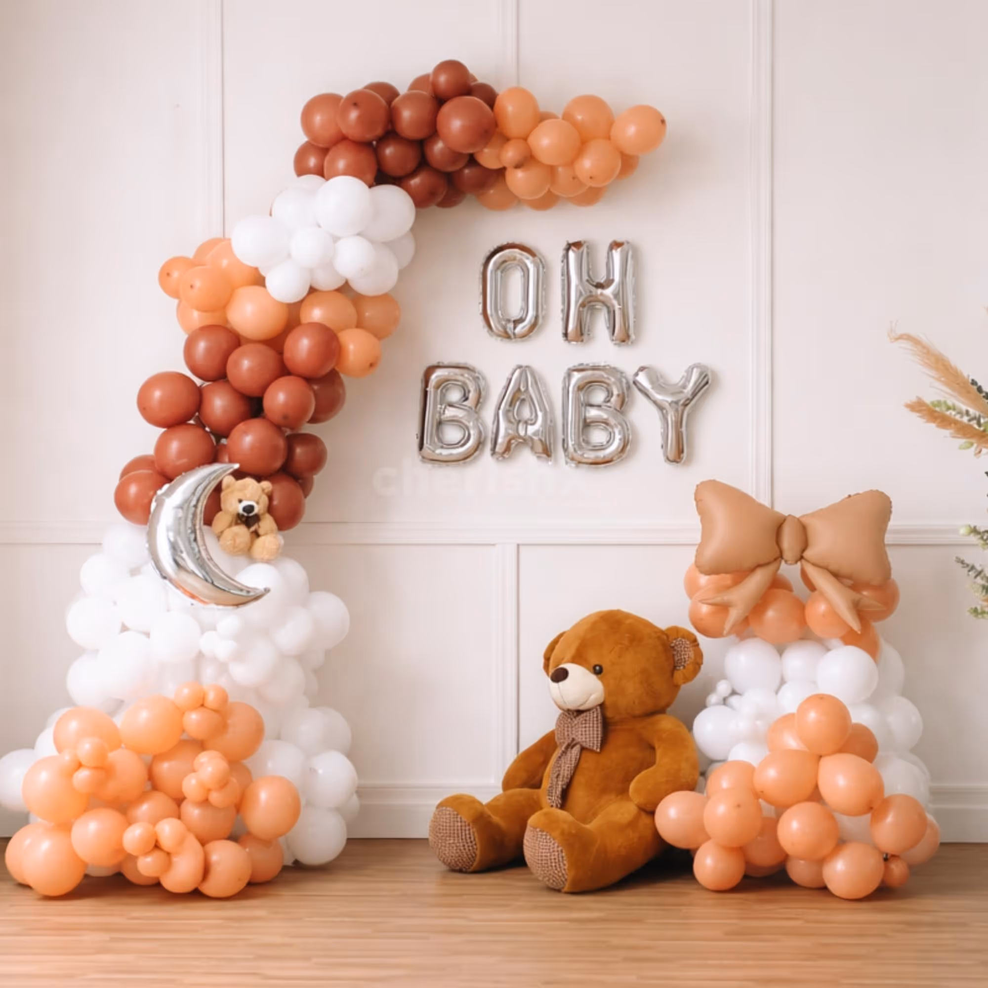 Mom-To-Be Standing Beside Baby Shower Balloon Decor With A Soft Theme