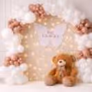 Soft-Tone Themed Baby Shower Setup With Pastel Balloons And A Cute Teddy