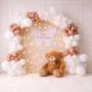 Balloon Arch Backdrop With Teddy Bear And Glowing Warm Lights For A Baby Shower Celebration