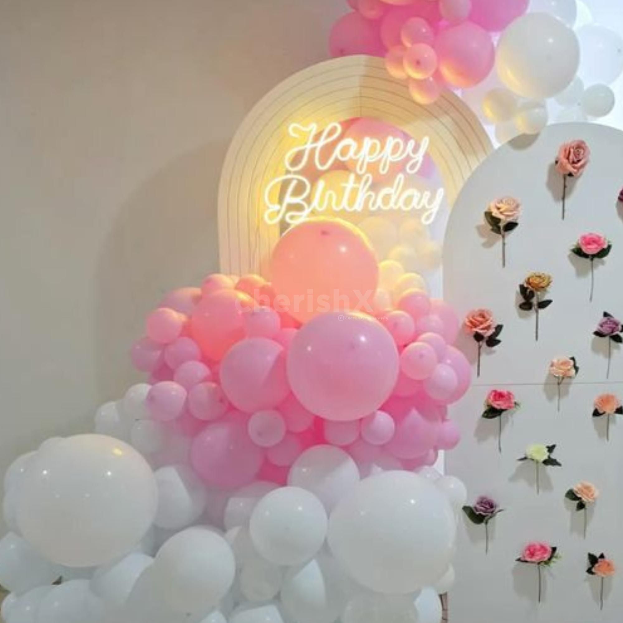 Balloons And Artificial Flower Arrangement Form A Classy Pink Birthday Theme.