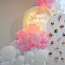 Balloons And Artificial Flower Arrangement Form A Classy Pink Birthday Theme.
