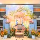 Baby Shower Decorations Include Blue Pedestal Tables With Brass Pots With Flowers.