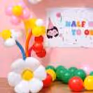 Pastel And Bright Balloons Form A Joyful Half-Birthday Atmosphere.