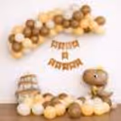 Vintage-Toned Half-Year Paper Bunting Hangs Elegantly Amid The Balloon Arch Backdrop.