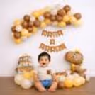 The Dinosaur And Cake Foil Balloons In The Decoration Add An Adventurous Feel To The Setup.
