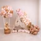 Balloon Arch In Multiple Sizes And Various Tones Of Balloons Adds Grace To A Half-Year Birthday Decor.