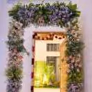 A Divine Look With A Toran And Garland Backdrop Symbolises A Prosperous Home Entry.