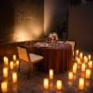 Romantic lighting and a glowing background with a charming candle-lined path to the proposal dining area